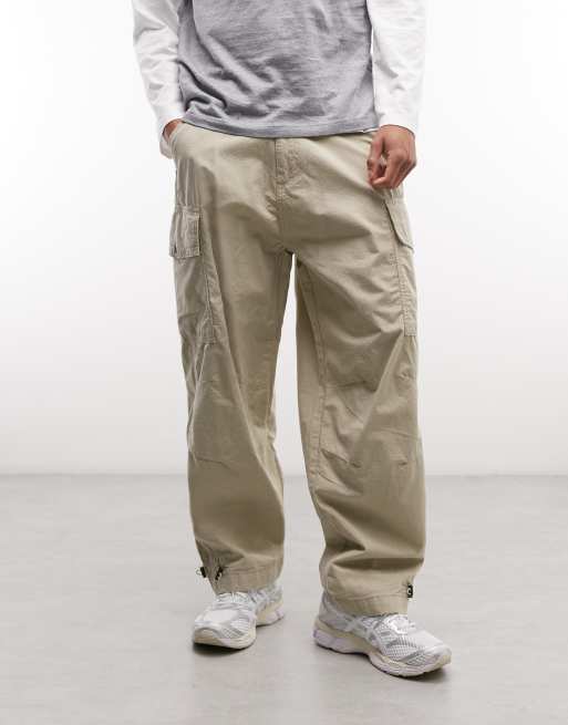 Alpha Industries cargo trousers with adjustable leg toggles in light beige, 2 of 5