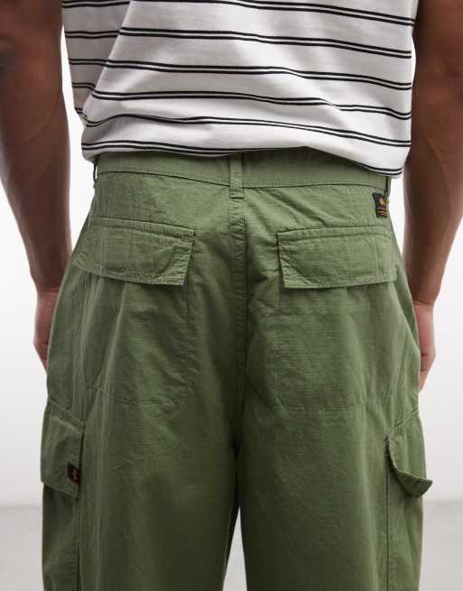 Alpha Industries - Pantalones caquis cargo con cordones ajustables en las perneras, 5 de 5