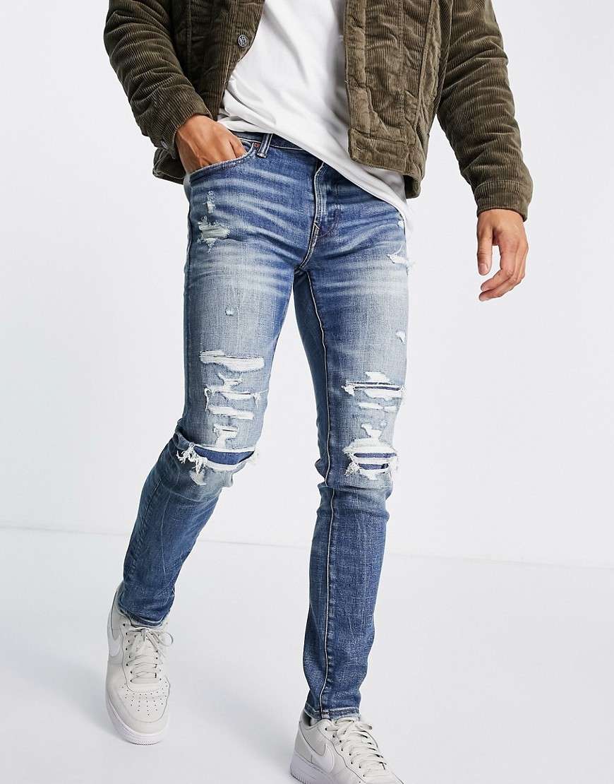 American Eagle - Skinny fit jeans in distressed model met herstelwerk en medium wassing-Blauw