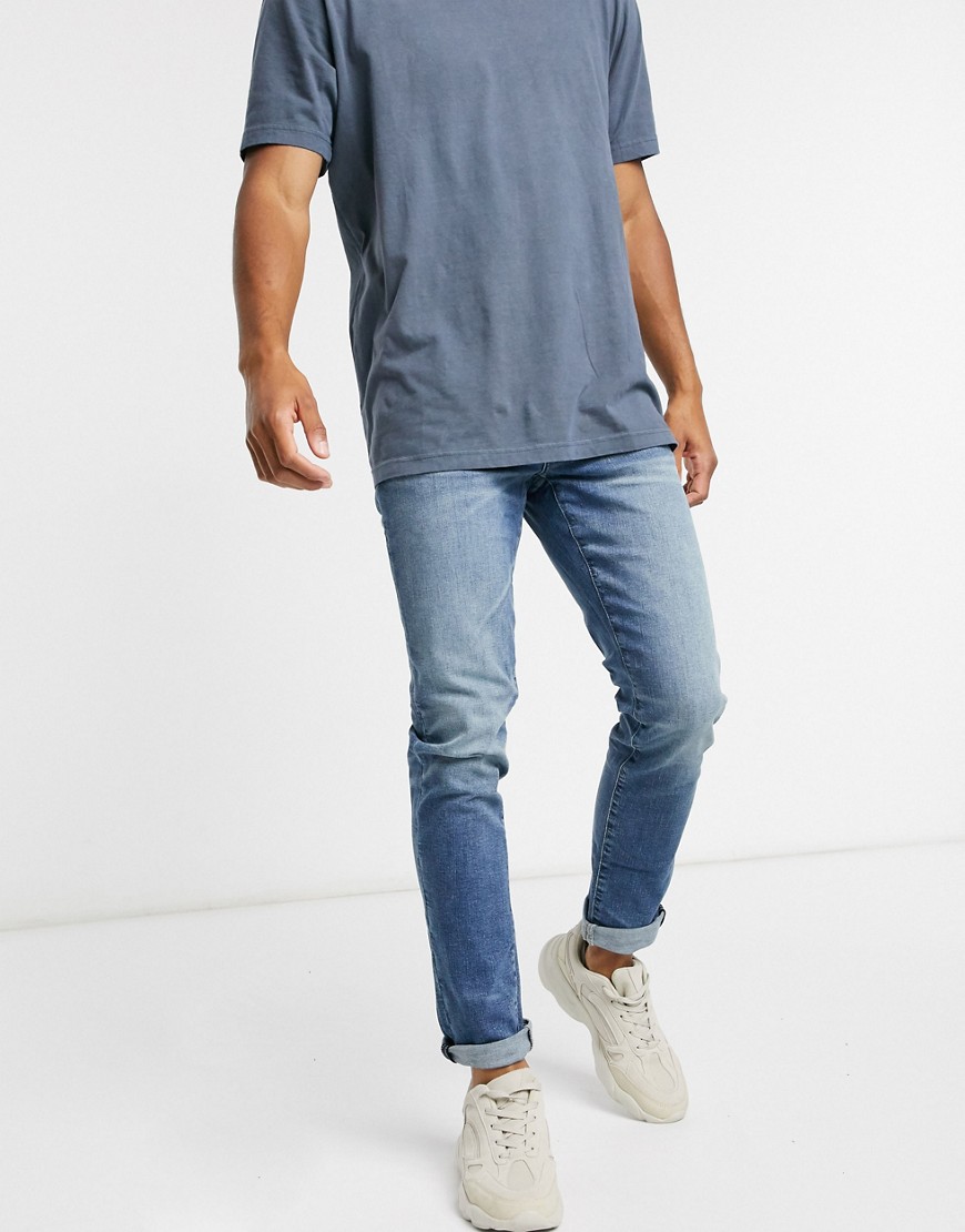 American Eagle - Smaltoelopende slim-fit jeans in vintage wassing-Blauw