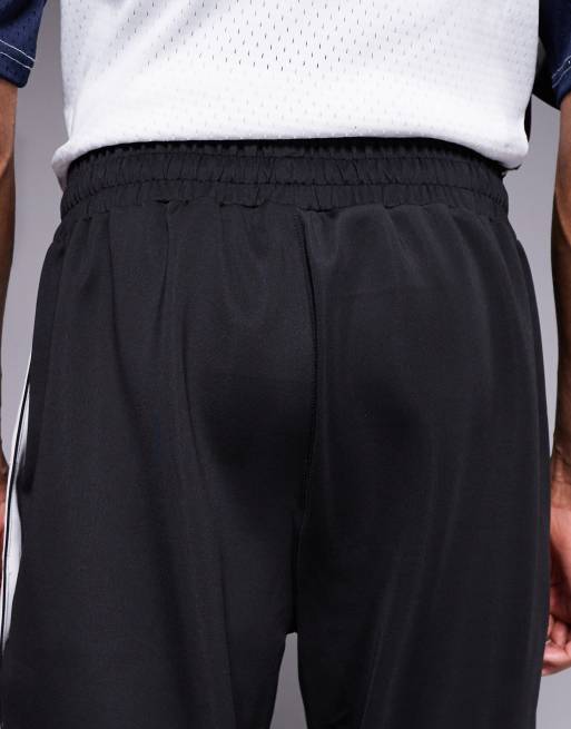 And1 – Gerade geschnittene Retro-Jogginghose in Schwarz mit Druckknöpfen, 4 von 5