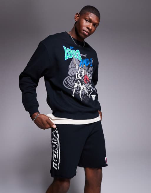 AND1 - Sorte oversized shorts med rå kanter og grafisk sportsprint