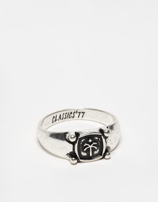Anillo tipo sello plateado con diseño grabado de palmera de Classics 77