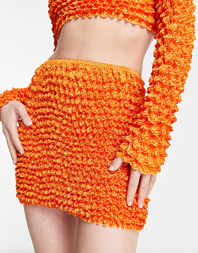 Annorlunda - popcorn textured super mini skirt co-ord in bright orange