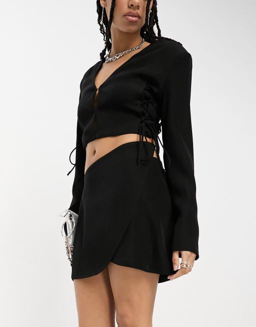 Black wrap over mini skirt hotsell