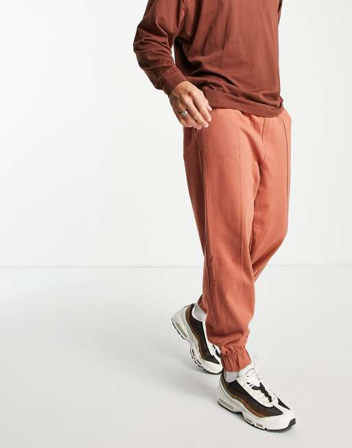 Another Influence raw seam detail relaxed fit trackies in brown (part ...