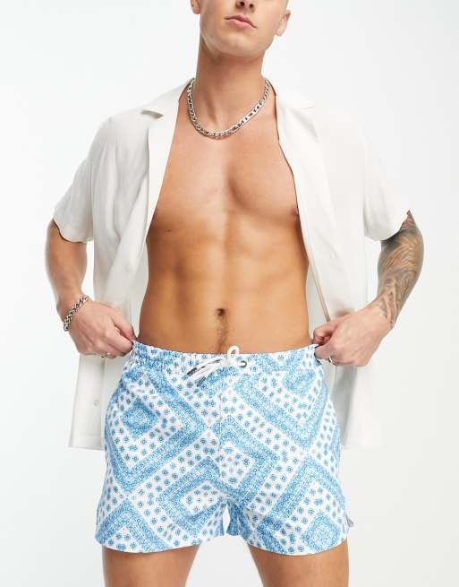 Another Influence swim shorts in blue and white geometric print