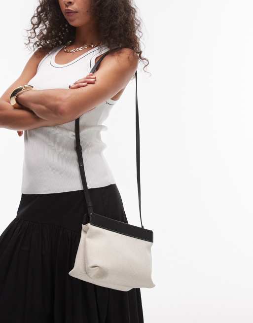 ARKET small canvas cross body bag with black leather details contrast stitches in light white neutral, 4 of 4
