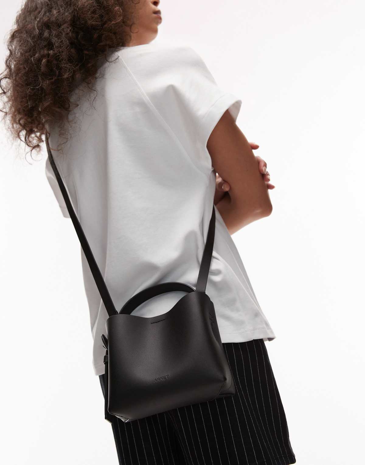 ARKET small leather cross body tote bag with side buckle detail in black