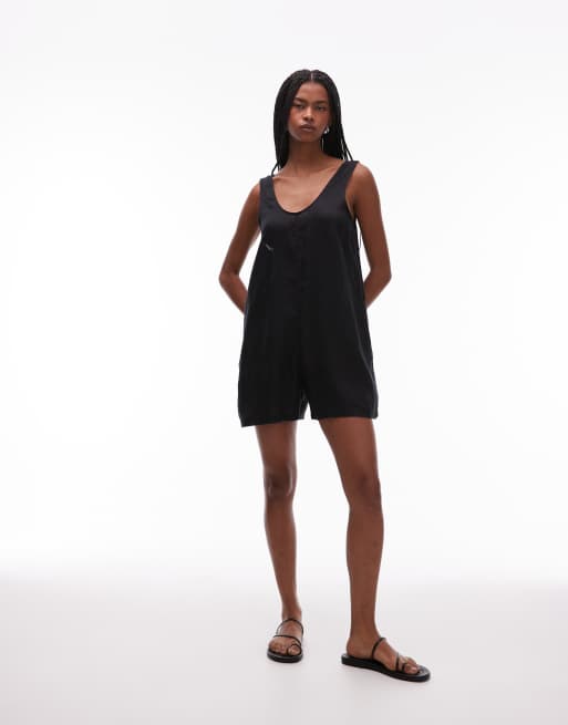 ARKET - Sort strand-playsuit med dyb V-hals og lommedetaljer i hør