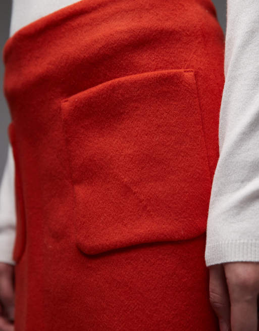 ARKET wool rich mini skirt with front pockets in orange