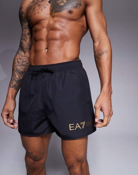 Armani EA7 gold logo swim shorts in black - view 1
