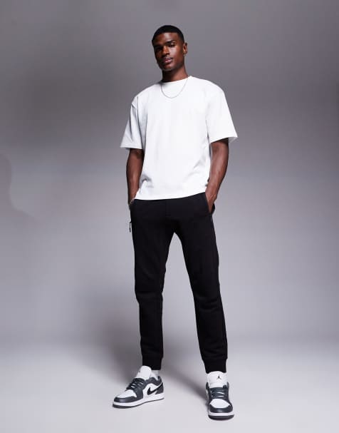 Armani Exchange logo cuffed trackies in black - view 1