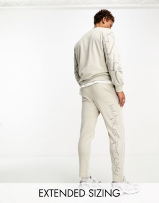 Armani Exchange scattered logo joggers light beige mix and match