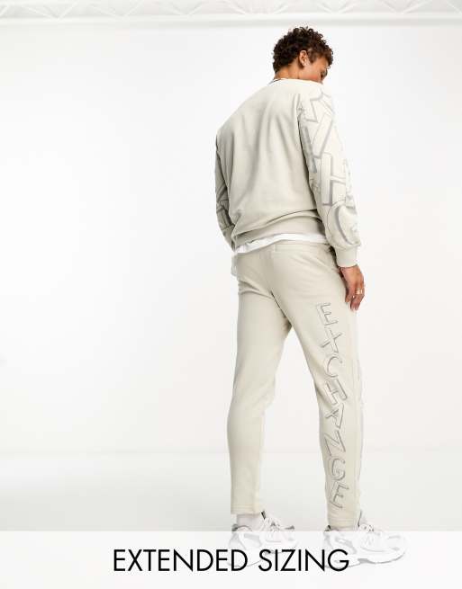 Armani Exchange scattered logo trackies in light beige mix and match