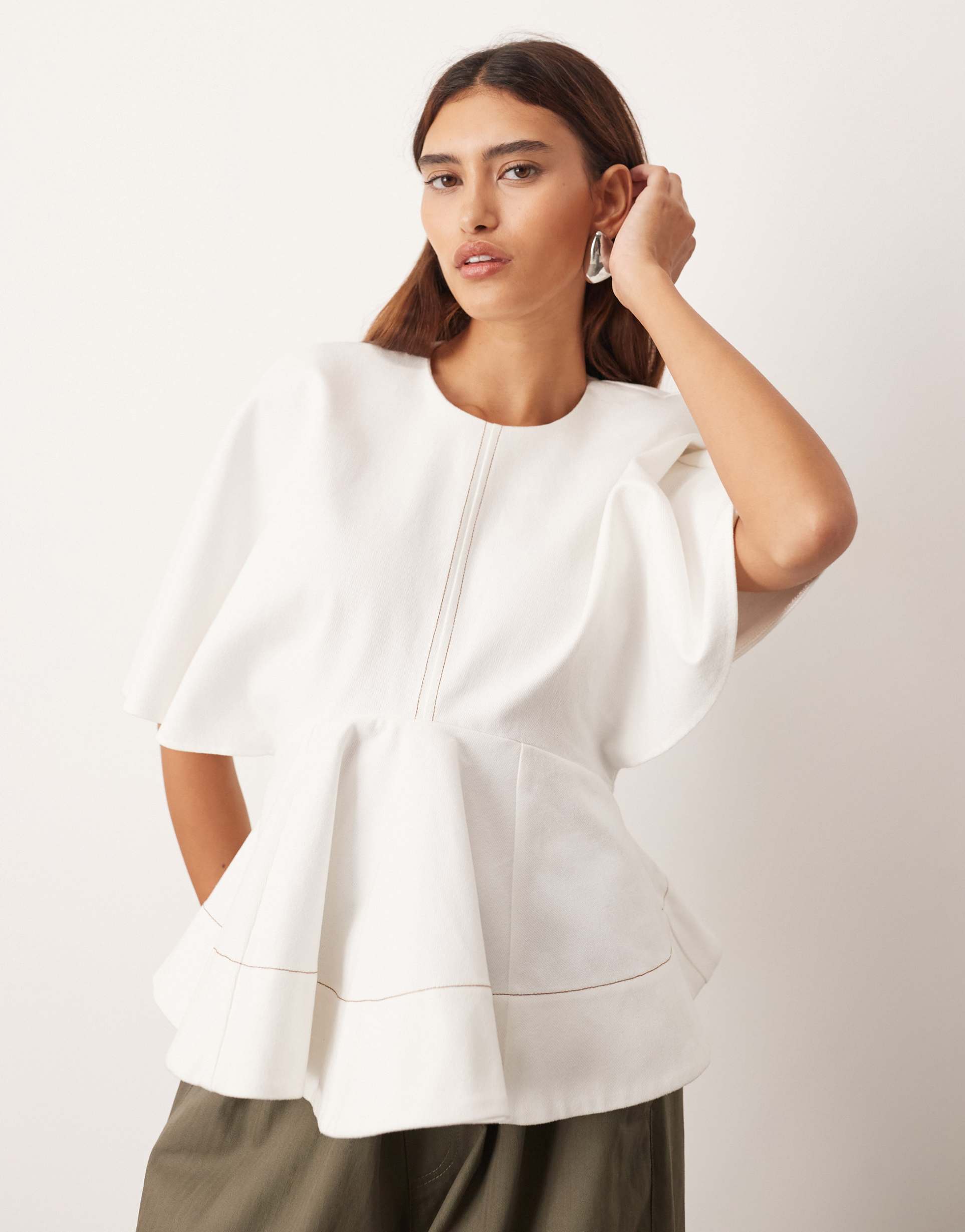 arrange batwing twill peplum hem top in ecru