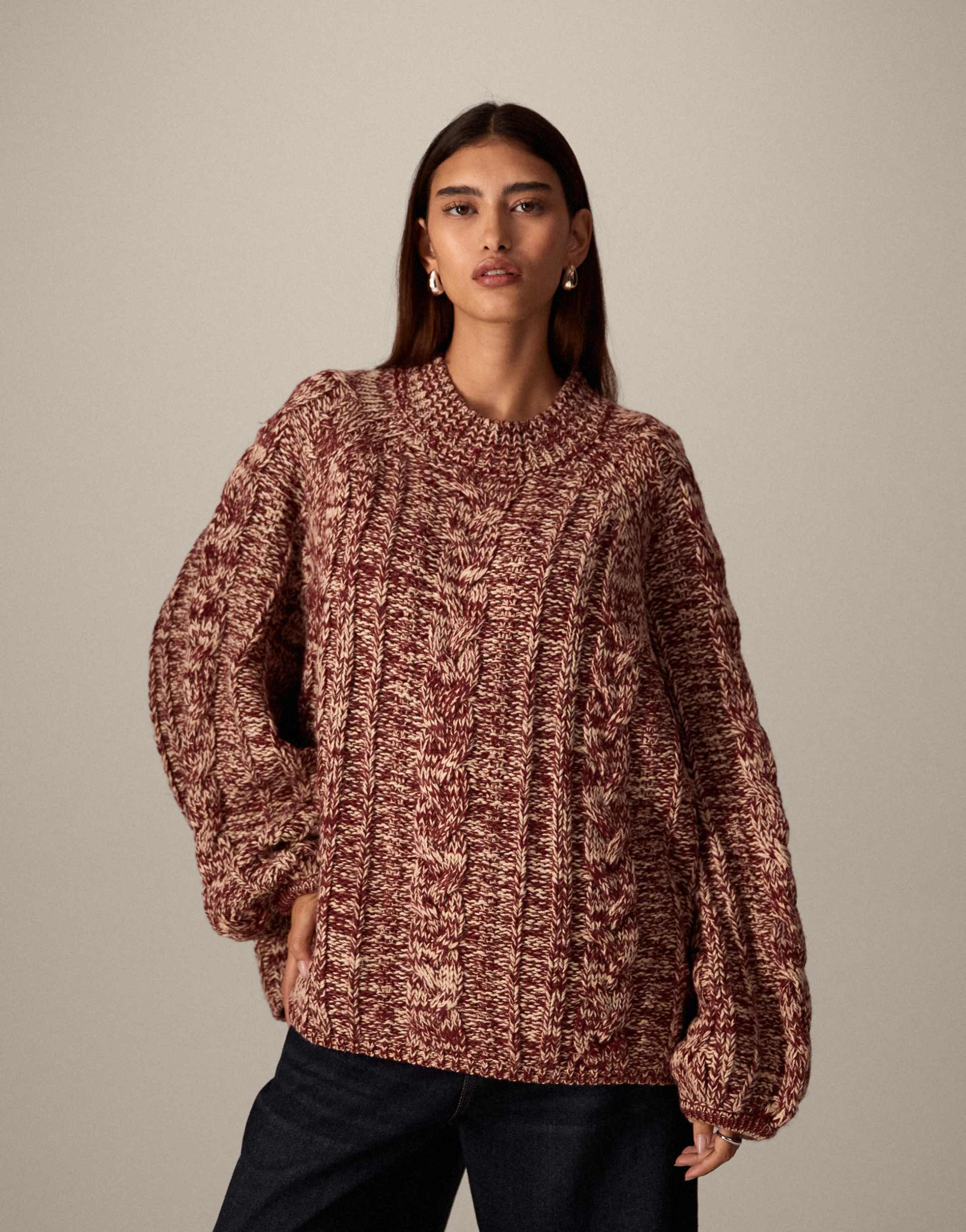 arrange cable knit high neck sweater with volume sleeves in twisted yarn in red and cream