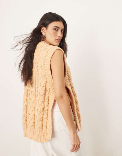 ARRANGE cable knit sleeveless sweater with tie detail in apricot