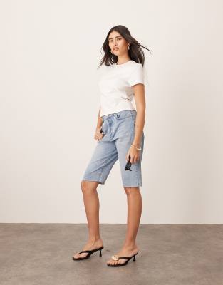ARRANGE ARRANGE Cleo denim longline short with raw hem in mid wash blue