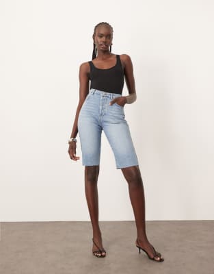 Cleo denim longline shorts with raw hem in mid wash blue