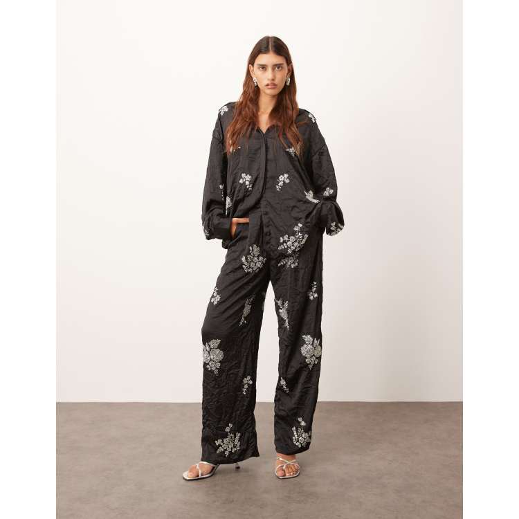 ARRANGE crinkle satin floral embellished pants in black - part of
