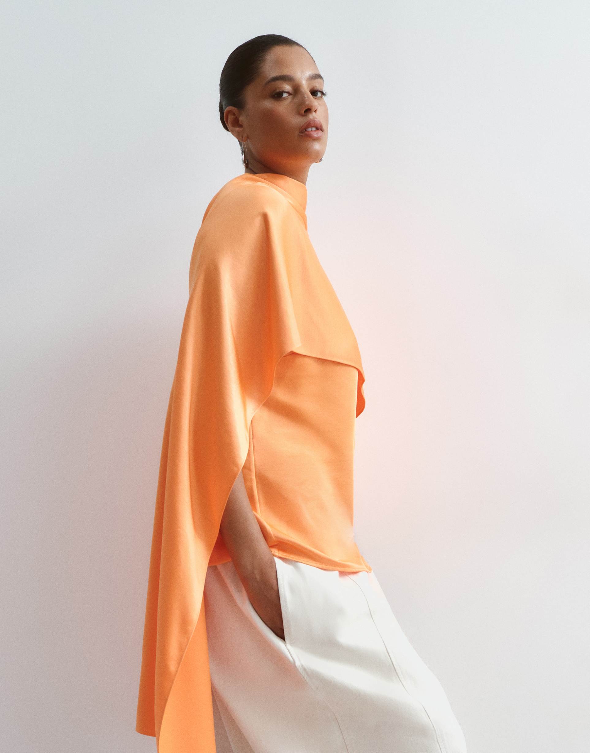 arrange curve satin underlay cape top in orange