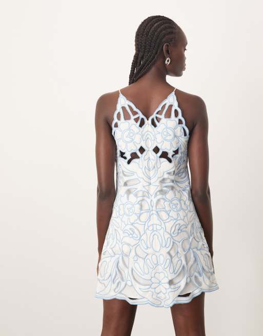ARRANGE floral cut work halterneck mini dress with contrast stitch in blue