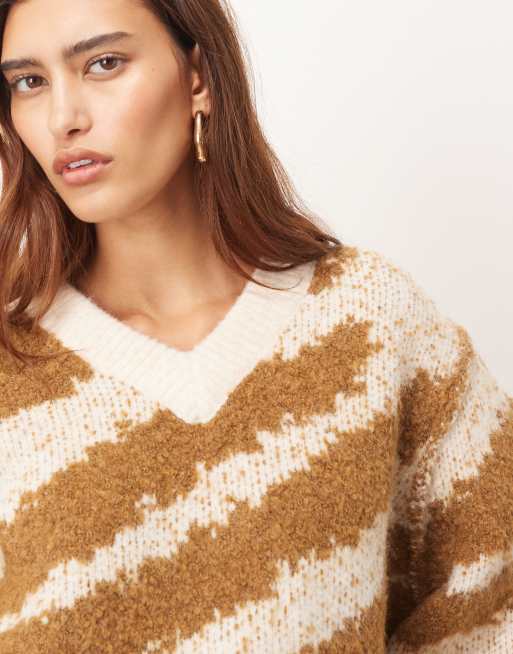 ARRANGE oversized knit v neck sweater with curved hem in toffee
