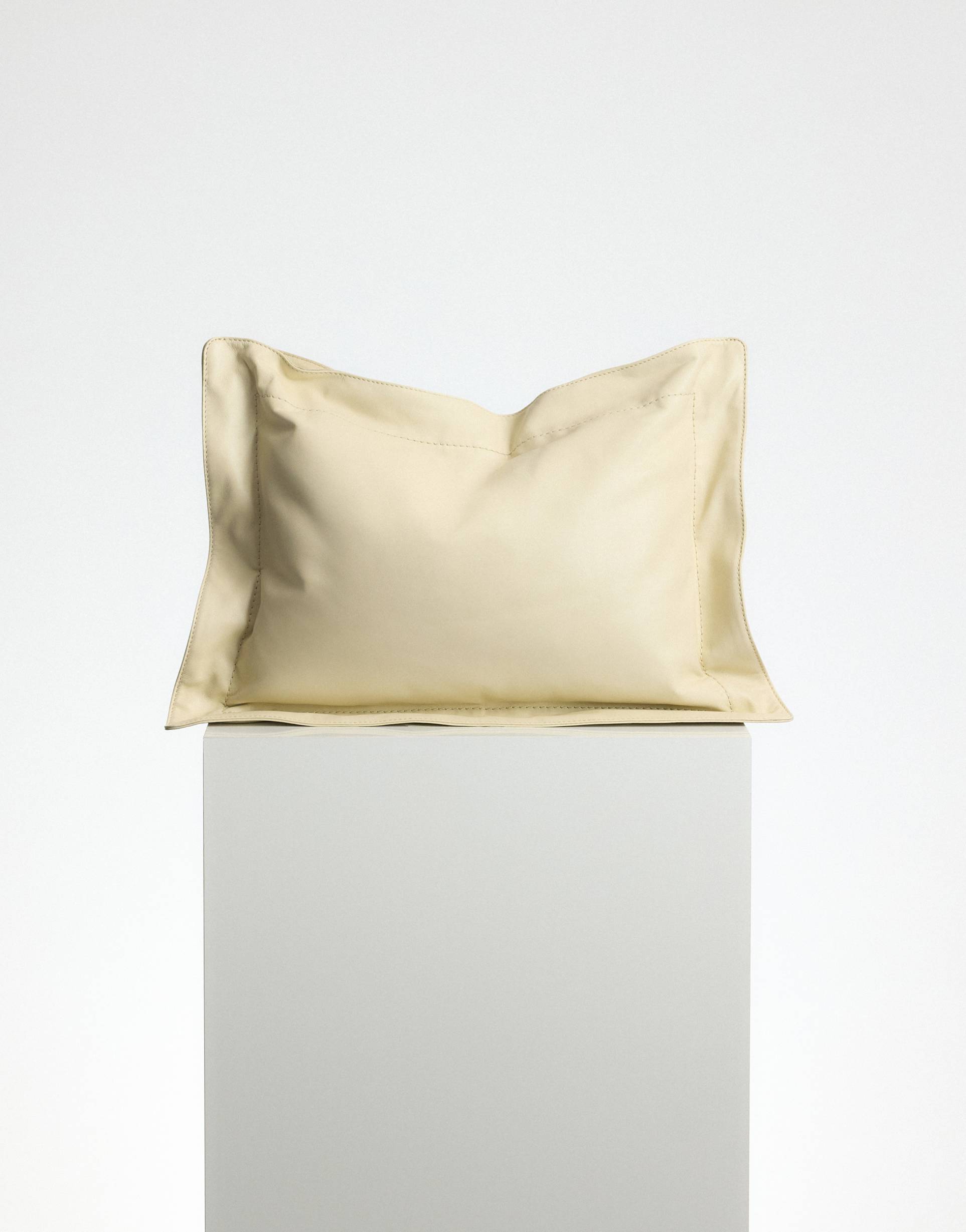 arrange pillow leather bag in buttermilk