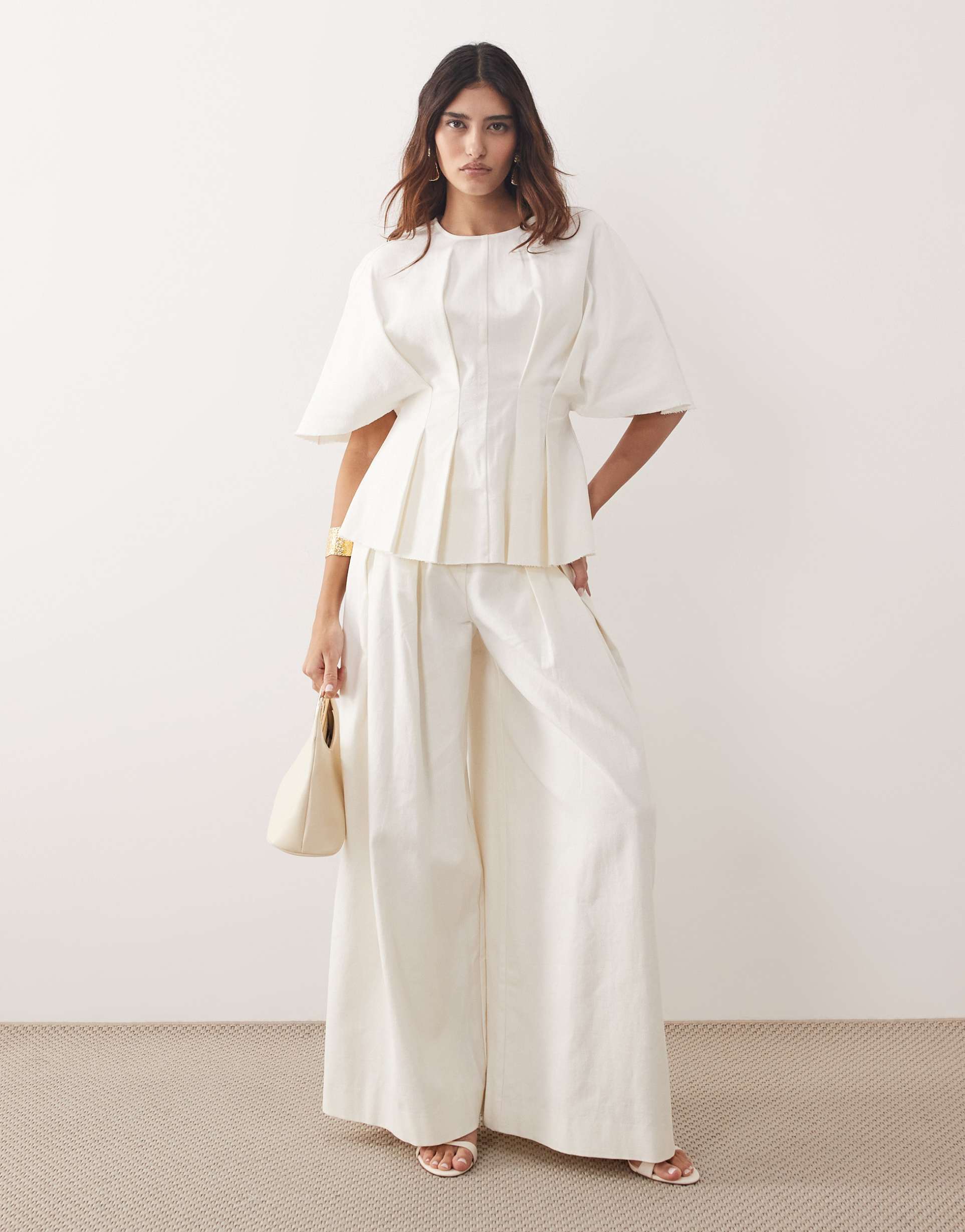 arrange pleated pants in white - part of a set