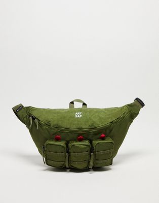 ARTSAC jaspar triple pocket sling cross body bag in khaki - ASOS Price Checker