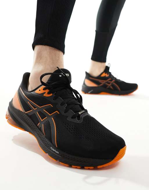 Asics GT 1000 12 GTX Stabilisierende Laufsneaker in Schwarz und Orange ASOS