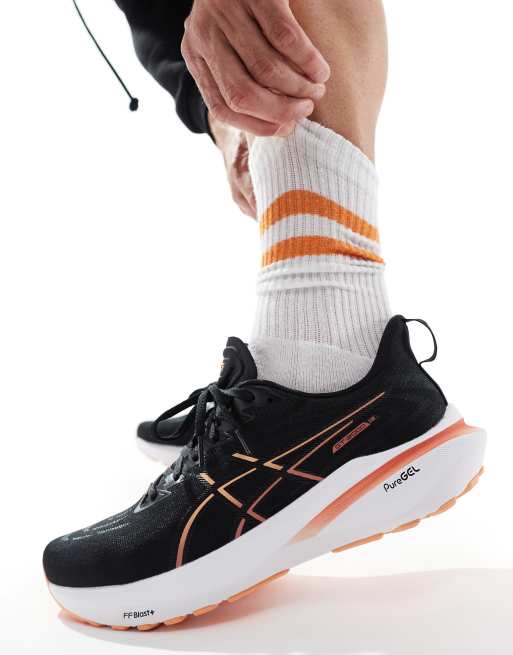 Asics GT 2000 13 Stabilisierende Laufsneaker in Schwarz und Orange ASOS