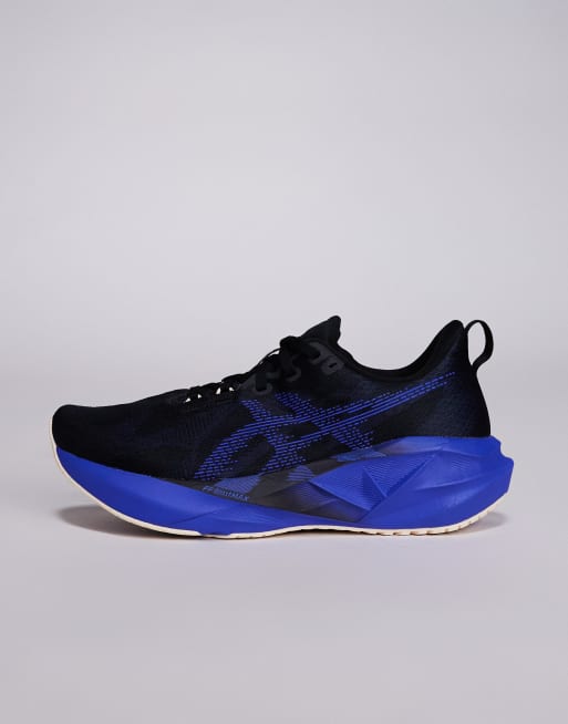 Asics Novablast 5 trainers in black and blue , 2 of 5