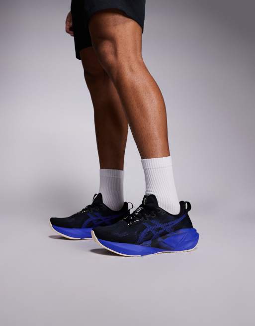 Asics Novablast 5 trainers in black and blue , 4 of 5