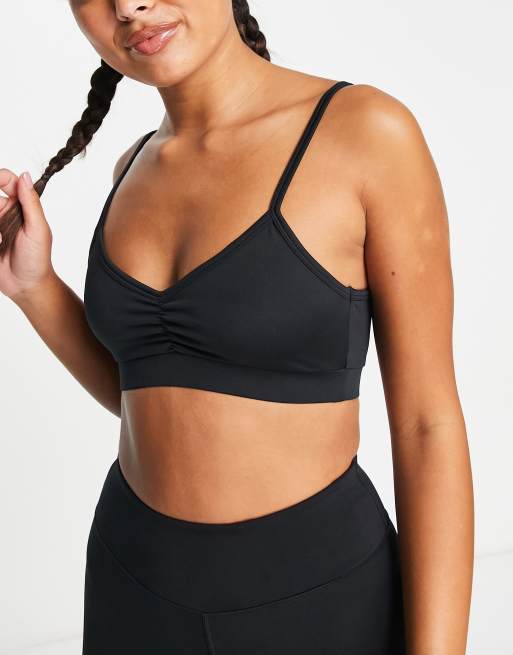 ASOS 4505 zip front medium support sports bra with back graphic in black