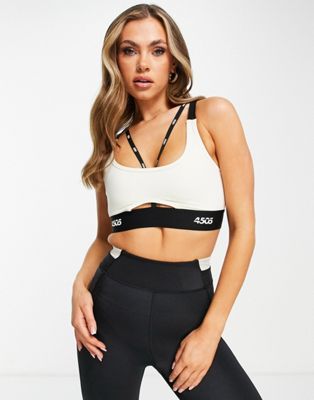 ASOS 4505 light support sports bra with skinny branded straps in cream