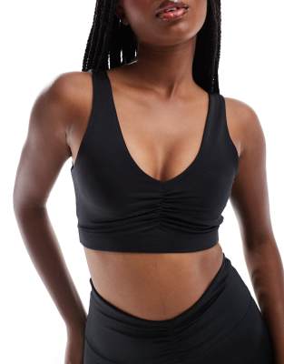 ASOS 4505 ruched front light support sports bra in high shine black