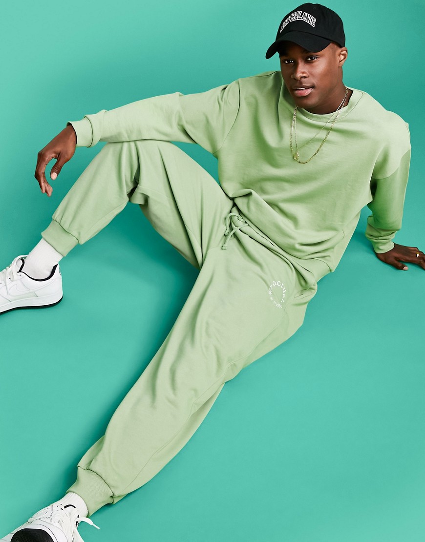 ASOS Actual Athleisure relaxed sweatpants in green with health and wellbeing logo print