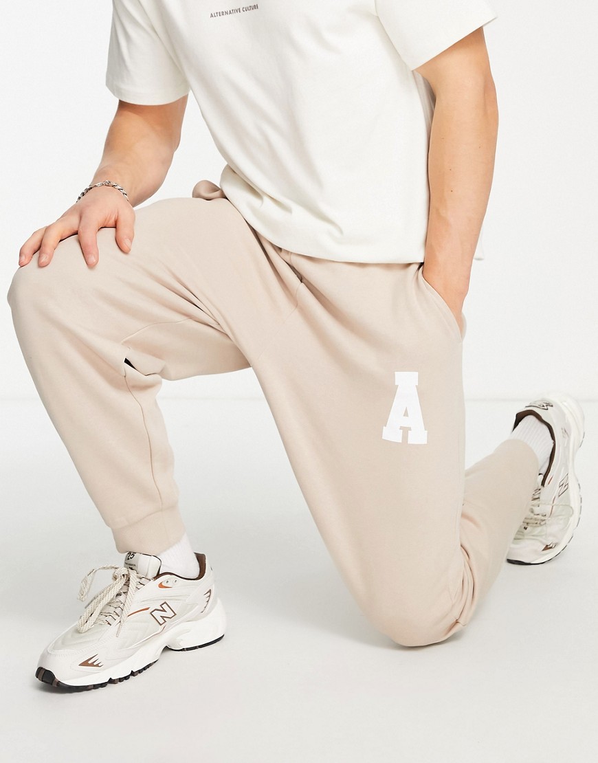 ASOS Actual Athleisure relaxed sweatpants with logo print in sand - part of a set-Neutral