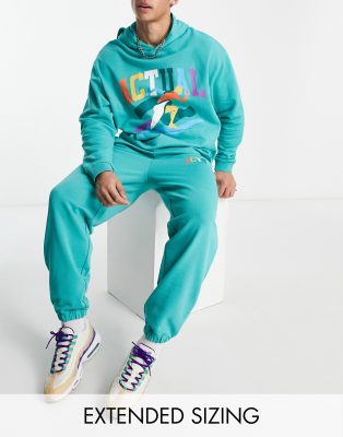 ASOS Actual relaxed trackies with multi colour logo print in teal (part of a set) - ASOS Price Checker