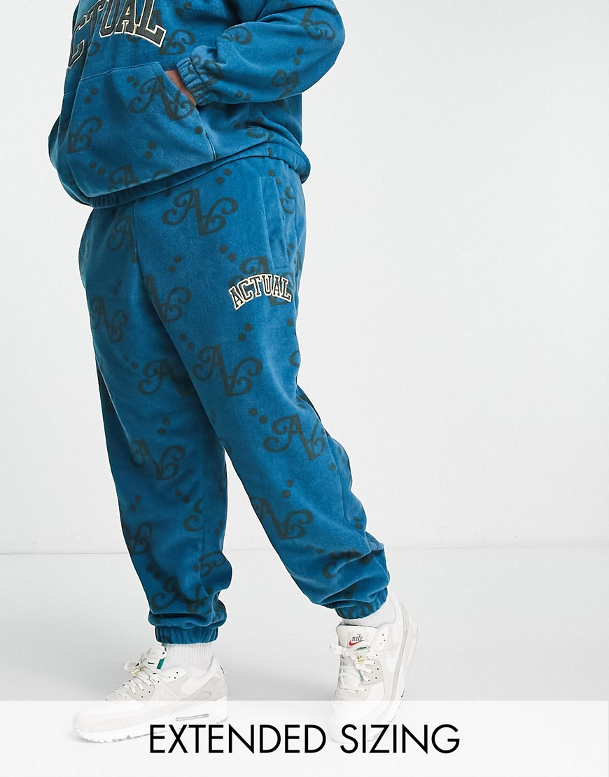 ASOS Actual co-ord relaxed polar fleece joggers with all over print and applique logo in blue