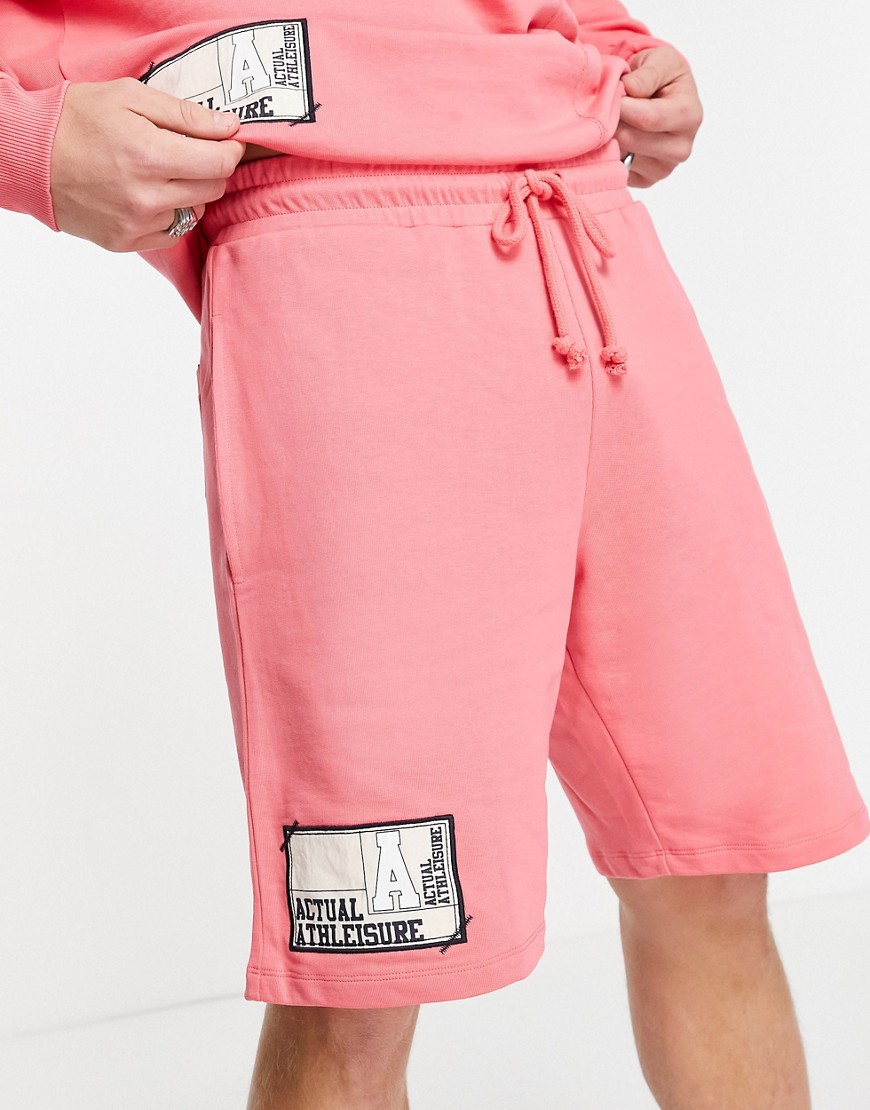 ASOS Actual coordinating oversized shorts with cut and sew paneling and logo woven patches in pink