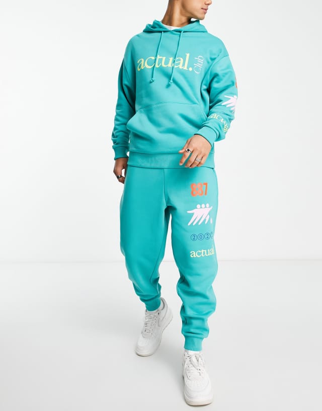 ASOS Actual relaxed sweatpants with actual club multi prints in green - part of a set