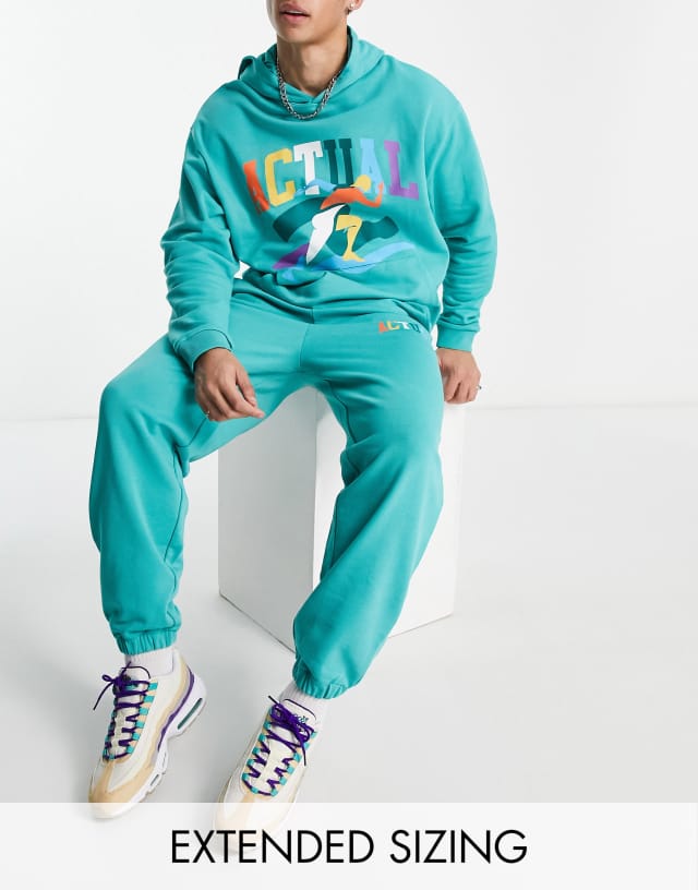 ASOS Actual relaxed sweatpants with multi color logo print in teal - part of a set