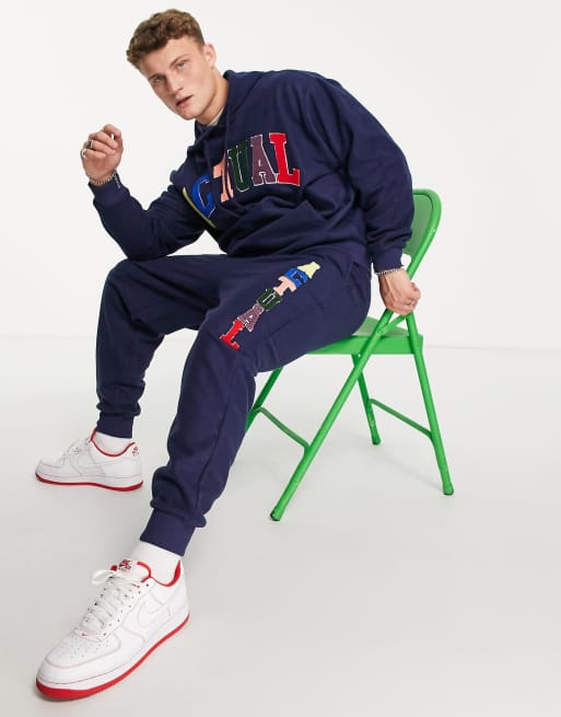 ASOS Actual relaxed trackies in polar fleece with colour pop logo applique in navy (Part of a set)