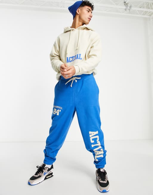 ASOS Actual relaxed trackies in polar fleece with logo prints in bright blue (part of a set)