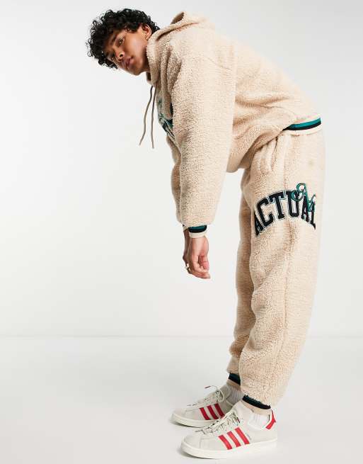 ASOS Actual relaxed trackies in teddy borg with applique logo and tipping in neutral (part of a set)