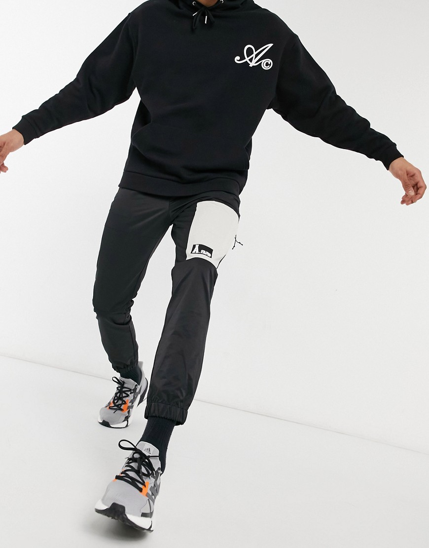 ASOS Actual sweatpants in black nylon with cut and sew paneling