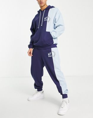 ASOS Actual sweatpants with cut and sew detail with logo print in blue ...